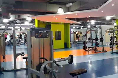 a gym with several tread machines and people in it at Jbr beach walk 2 bedrooms front sea in Dubai