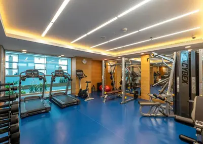 a gym with several tread machines in a room at Gulf Inn Hotel Al Nasr Formerly Roda Links Al Nasr in Dubai