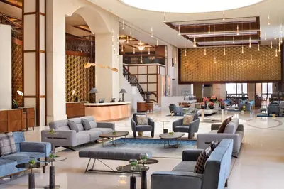 a lobby of a hotel with couches and tables at Crowne Plaza - Dubai Jumeirah by IHG in Dubai