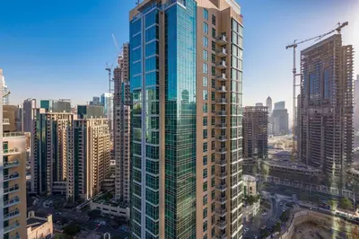 a view of a tall building in a city at One Bedroom Apartment Dubai Fountain & Old Town View by Auberge in Dubai