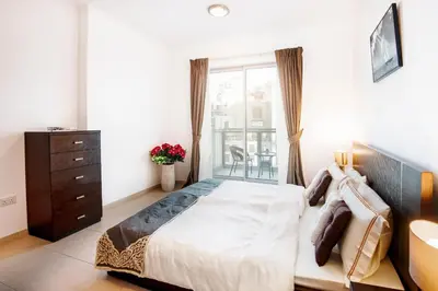 a bedroom with a large bed and a window at One Bedroom Apartment Dubai Fountain & Old Town View by Auberge in Dubai