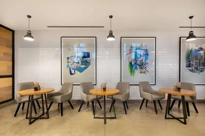 a restaurant with tables and chairs in a room at Rove Dubai Marina in Dubai
