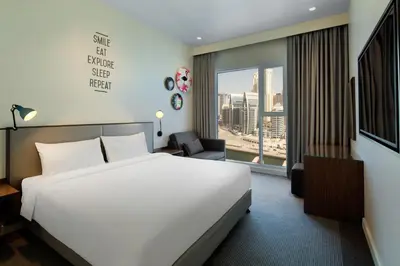 a hotel room with a bed and a window at Rove Dubai Marina in Dubai