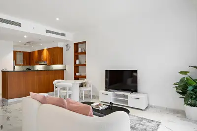 a living room with a couch and a table at Studio Central Park DIFC in Dubai