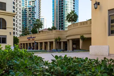 a building in the middle of some tall buildings at ELAN Rimal 3 Suites in Dubai