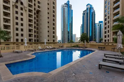 a swimming pool in the middle of a city with tall buildings at ELAN Rimal 3 Suites in Dubai