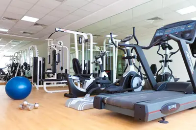 a gym with several treadmills and exercise bikes at Marina Byblos Hotel in Dubai