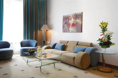 a living room with a couch and a table at Marina Byblos Hotel in Dubai