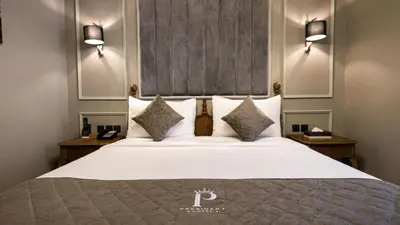 a bedroom with a large white bed with two night stands at President Hotel in Dubai