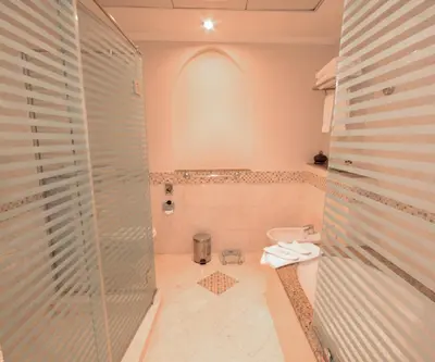 a bathroom with a shower and a sink and a toilet at Coral Boutique Villas in Dubai
