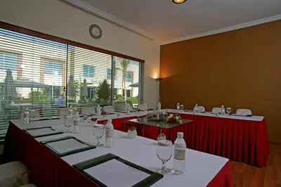 a large room with a long table with red tables and glasses at Coral Boutique Villas in Dubai