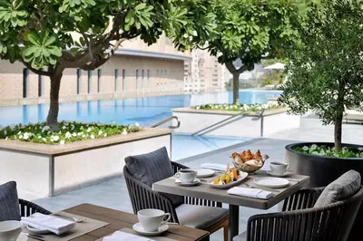 a table and chairs on a patio with a pool at Westminster Dubai Mall in Dubai