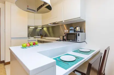 a kitchen with a white counter top with fruits on it at Westminster Dubai Mall in Dubai