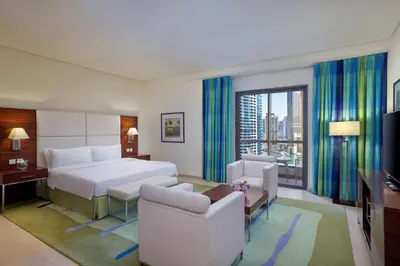 a hotel room with a bed and a large window at Hilton Dubai The Walk in Dubai