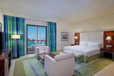 a hotel room with a bed and a large window at Hilton Dubai The Walk in Dubai