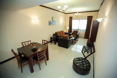 an overhead view of a living room with a table and chairs at Xclusive Maples Hotel Apartment in Dubai