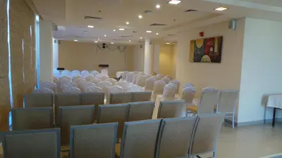 a room with rows of chairs in a room at Xclusive Maples Hotel Apartment in Dubai