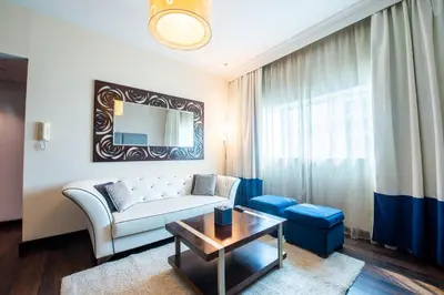 a living room with a couch and a table at First Central Hotel Suites in Dubai