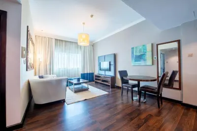 a living room with a table and a dining room at First Central Hotel Suites in Dubai