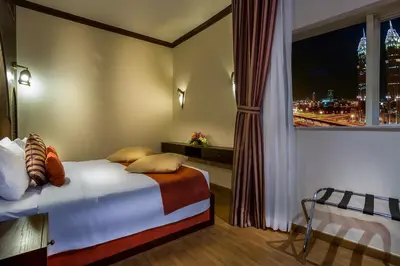 a bedroom with a bed and a window with a view at First Central Hotel Suites in Dubai