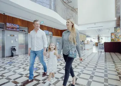 a family walking through a shopping mall at First Central Hotel Suites in Dubai