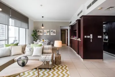 a living room with a couch and a table at Maison Privee - Exclusive Apt with Burj Khalifa Next Door in Dubai