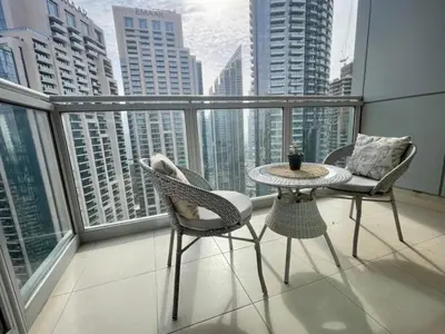 a balcony with a table and chairs on a balcony at Maison Privee - Exclusive Apt with Burj Khalifa Next Door in Dubai