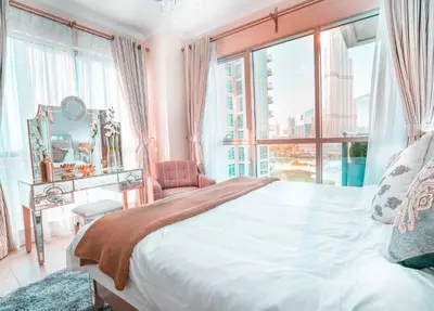 a bedroom with a large bed and a large window at Elite Royal Apartment - Burj Residences Tower 5 in Dubai