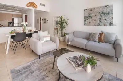 a living room with a couch and a table at Frank Porter - Canal Residence in Dubai