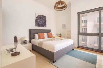 a bedroom with a bed with a dog on it at Frank Porter - Canal Residence in Dubai