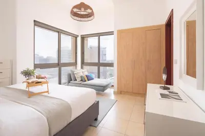 a bedroom with a king sized bed and a couch at Frank Porter - Canal Residence in Dubai