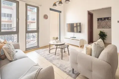 a living room with a couch and a table at Frank Porter - Canal Residence in Dubai