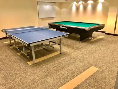 two ping pong tables sitting in a room with at Park Island, Dubai Marina in Dubai