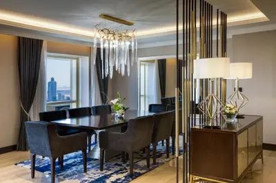 a dining room with a table and chairs and a chandelier at The Tower Plaza Hotel Dubai in Dubai