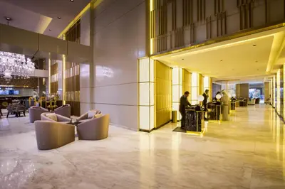 a lobby of a building with people standing in it at The Tower Plaza Hotel Dubai in Dubai