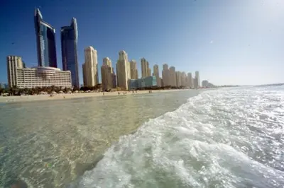 a view of a beach with a city in the background at 2br Beach front Sea View in Dubai