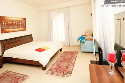 a bedroom with a bed and a teddy bear in it at 2br Beach front Sea View in Dubai