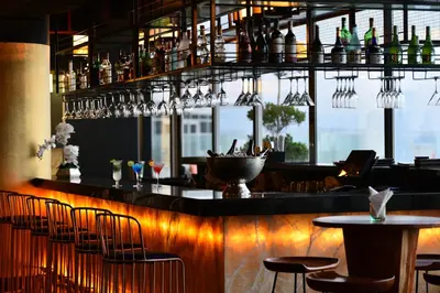 a bar with chairs and wine glasses in a restaurant at Royal Central Hotel and Resort The Palm in Dubai