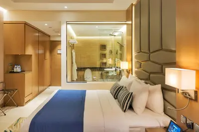 a bedroom with a large bed and a window at Royal Central Hotel and Resort The Palm in Dubai