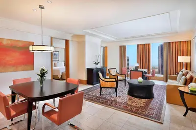 a living room with a dining table and a living room at Ritz Carlton Residences DIFC Downtown Dubai in Dubai