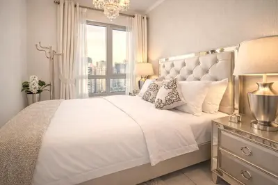 a bedroom with a large white bed with a window at Elite Royal Apartment - Full Burj Khalifa & Fountain View - Premium in Dubai