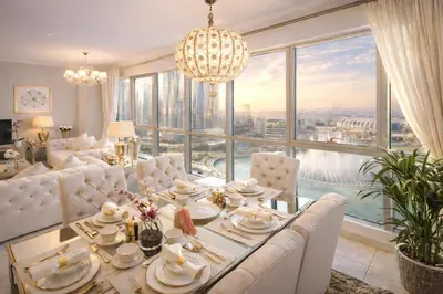 a living room with a table and a large window at Elite Royal Apartment - Full Burj Khalifa & Fountain View - Premium in Dubai