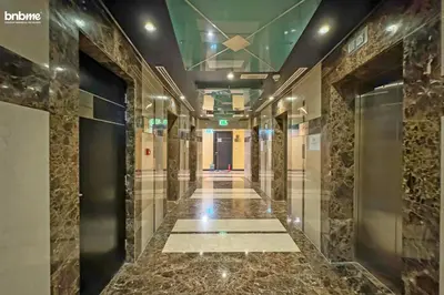 a hallway of a building with marble floors and a elevator at bnbmehomes - Gold Crest Views 2 in Dubai