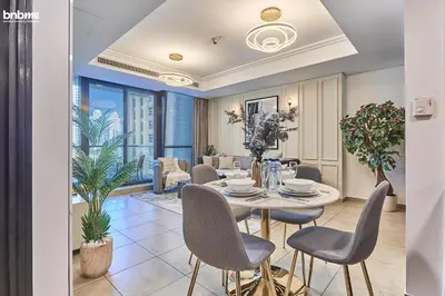 a dining room with a table and chairs at bnbmehomes - Gold Crest Views 2 in Dubai