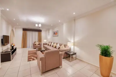 a living room with a couch and a tv at Pearl Marina Hotel Apartments in Dubai