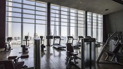 an empty gym with a view of the city at 1BR Burj Khalifa View Index Tower DIFC in Dubai