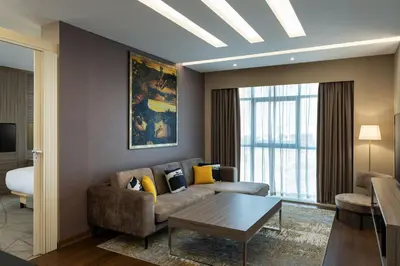 a living room with a couch and a table at Four Points by Sheraton Production City, Dubai in Dubai