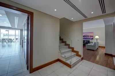 a lobby with stairs and a living room at J5 Villas Holiday Homes Barsha Gardens in Dubai