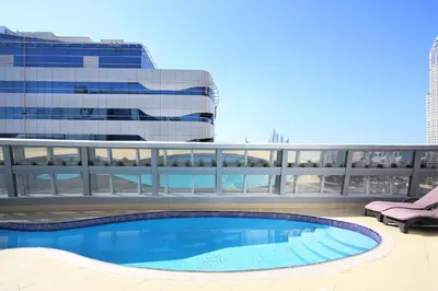 a swimming pool on the roof of a building at Citadines Metro Central Dubai in Dubai