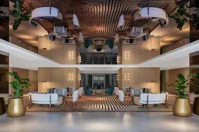 a lobby of a hotel with chairs and tables at Delta Hotels by Marriott Dubai Investment Park in Dubai